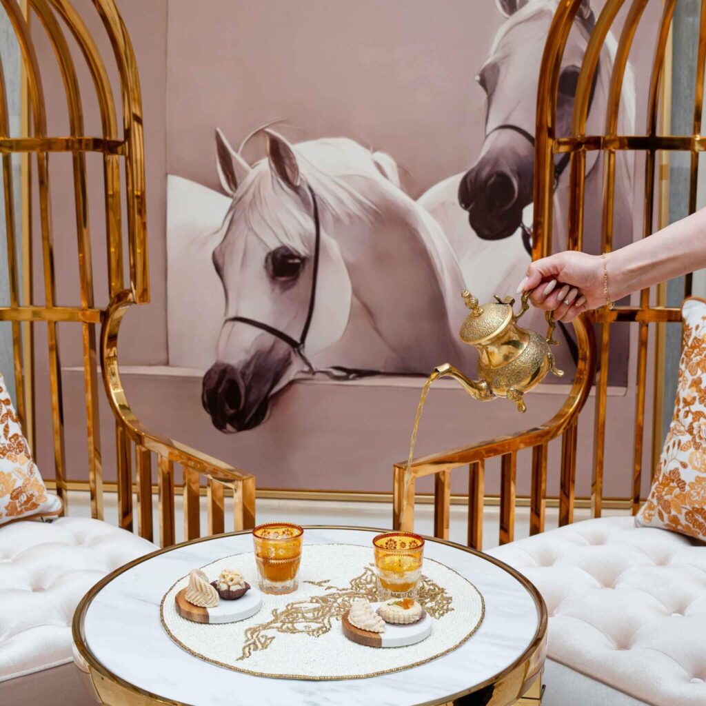 lady poring tea in a stylish tea cup