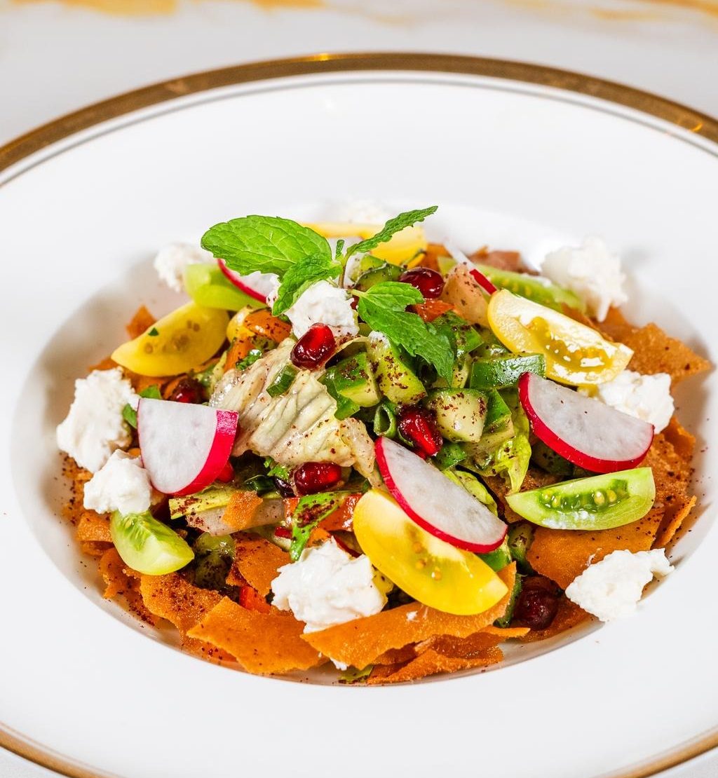 Delicious food with salad on top